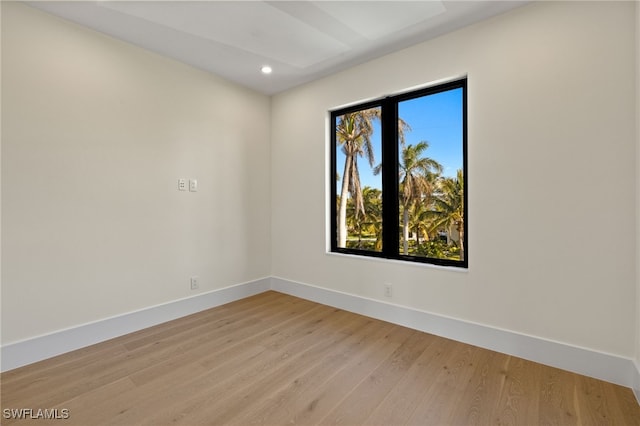 unfurnished room with recessed lighting, light wood-style flooring, and baseboards