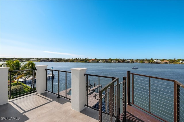 dock area featuring a water view and a balcony