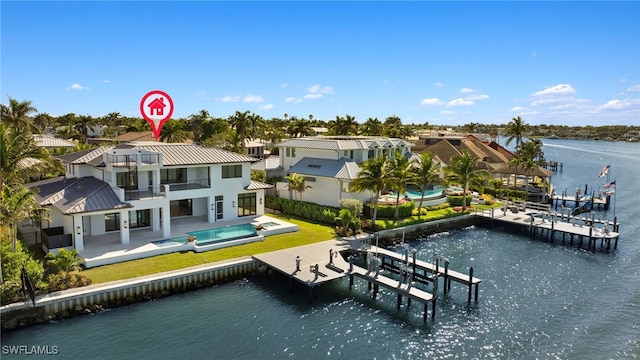 back of house with a patio area, a water view, and a balcony