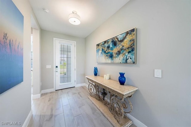 4016 Pegasus Way, Naples, FL 34120 - doorway with baseboards and light wood-style flooring