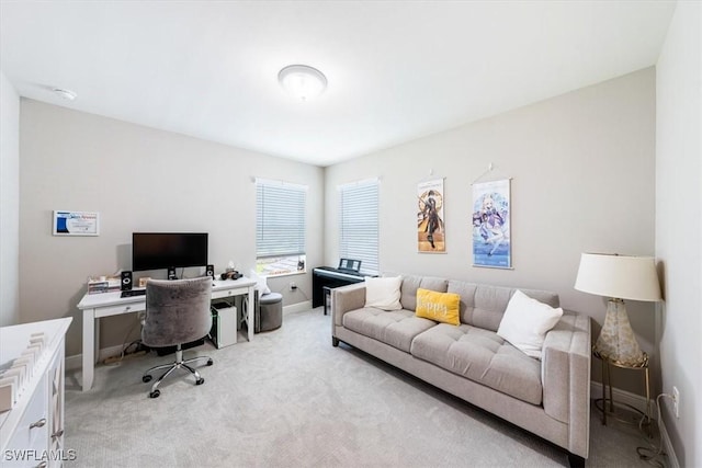 office with baseboards and light colored carpet