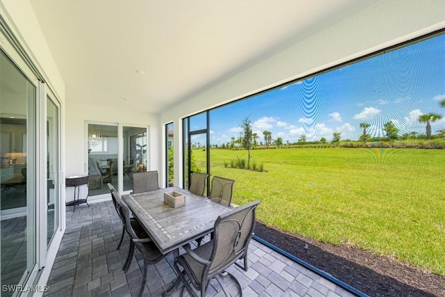 unfurnished sunroom featuring a rural view