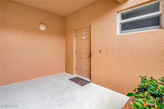 doorway to property featuring a patio area