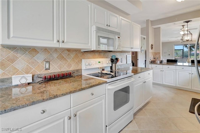 kitchen with white appliances, backsplash, light tile patterned flooring, light stone counters, and white cabinetry