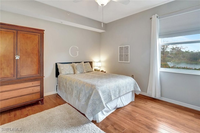 bedroom featuring ceiling fan and light hardwood / wood-style flooring