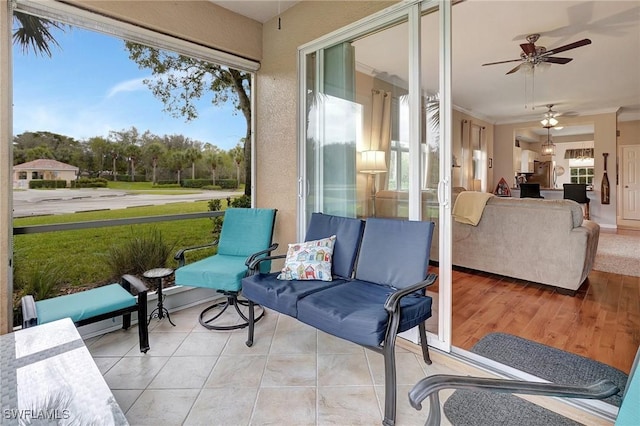 sunroom featuring ceiling fan