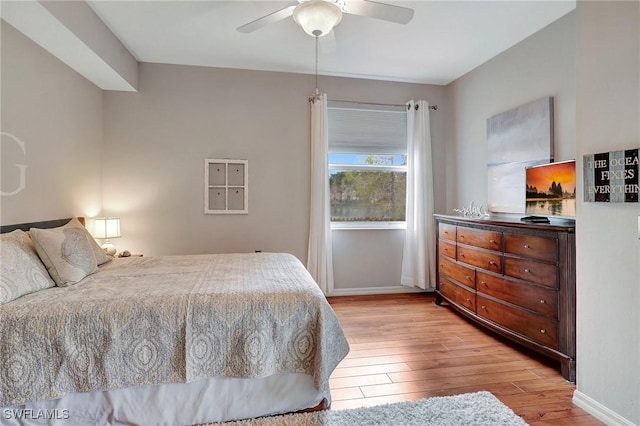 bedroom with light hardwood / wood-style floors and ceiling fan