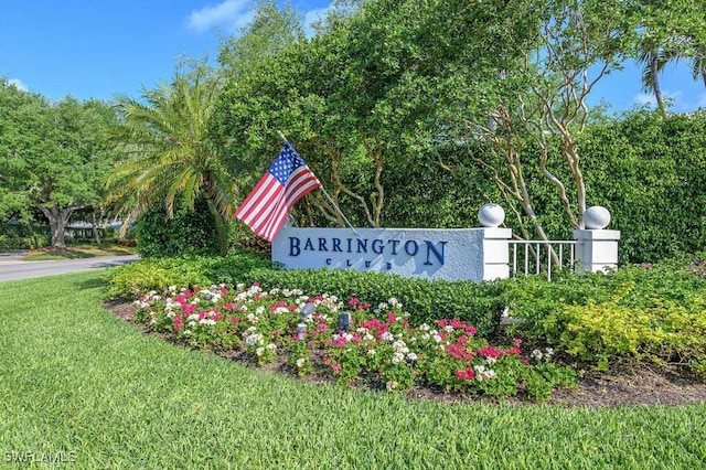 community sign featuring a lawn