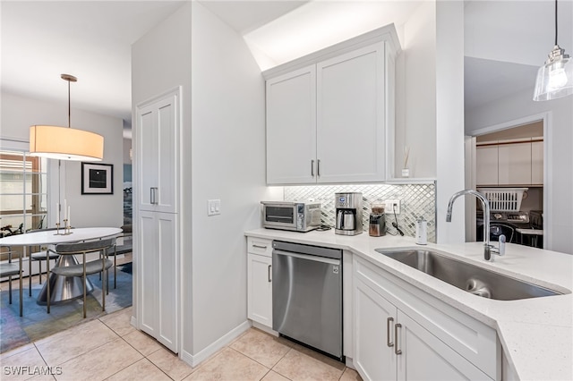 kitchen with pendant lighting, sink, white cabinets, and dishwasher