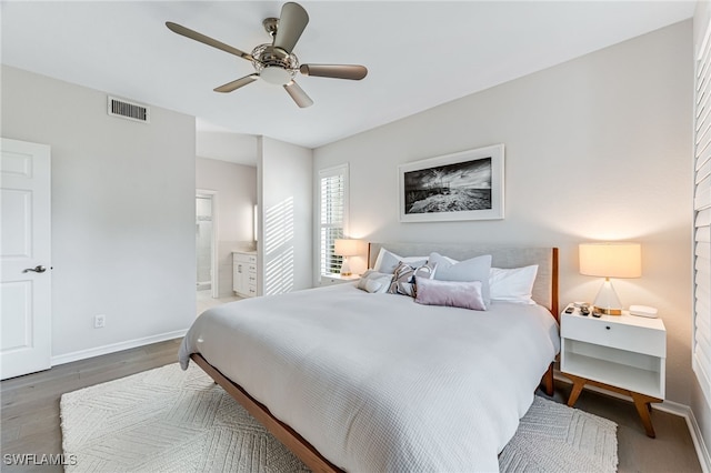 bedroom with dark hardwood / wood-style floors, ceiling fan, and ensuite bathroom