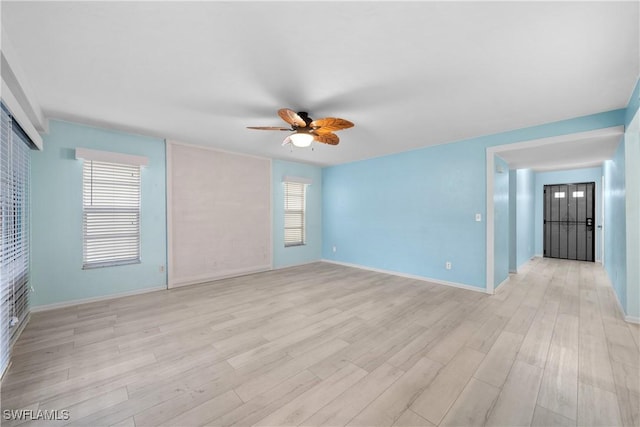 empty room with light hardwood / wood-style floors and ceiling fan