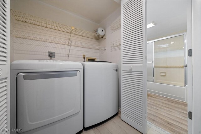 clothes washing area with washing machine and clothes dryer