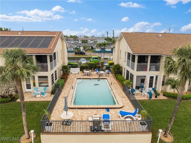 view of swimming pool featuring a yard and a patio