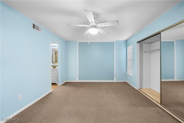 unfurnished bedroom featuring a closet, ceiling fan, and light colored carpet