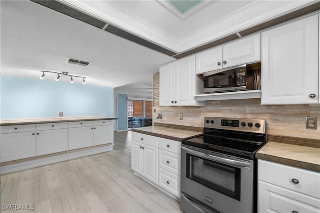 kitchen featuring wooden counters, tasteful backsplash, crown molding, white cabinets, and stainless steel electric range oven