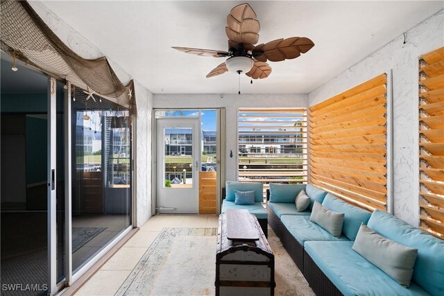 sunroom featuring ceiling fan