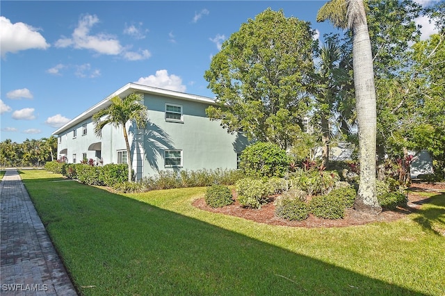 view of side of property featuring a yard