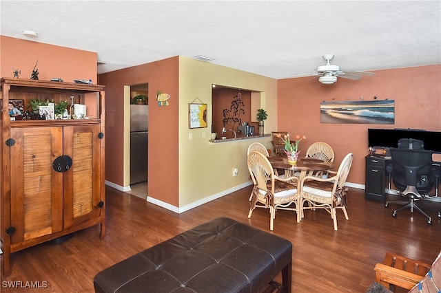 dining space featuring ceiling fan, dark hardwood / wood-style flooring, and a textured ceiling