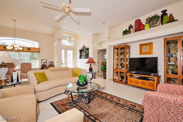 living room featuring french doors, ceiling fan with notable chandelier, light tile patterned floors, and a wealth of natural light