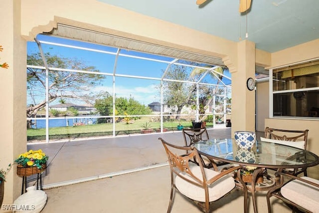 view of patio / terrace with a water view and glass enclosure