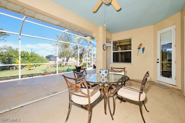 view of patio / terrace with ceiling fan and glass enclosure