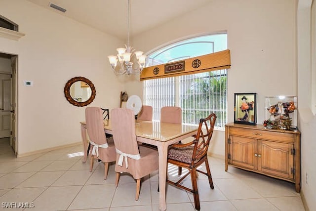 dining area with an inviting chandelier, light tile patterned floors, and high vaulted ceiling