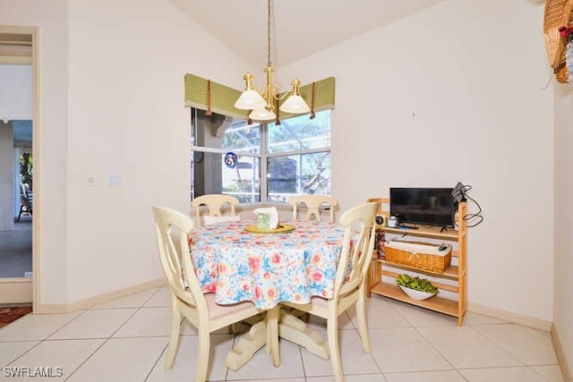 dining area featuring lofted ceiling, a notable chandelier, and light tile patterned flooring