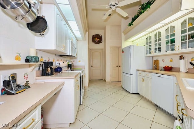 kitchen featuring white cabinetry, light tile patterned floors, ceiling fan, and white appliances