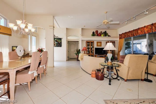 living room featuring light tile patterned floors, ceiling fan with notable chandelier, and rail lighting