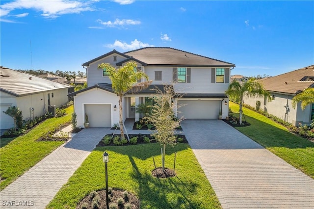 view of front of property featuring central AC, a front lawn, and a garage