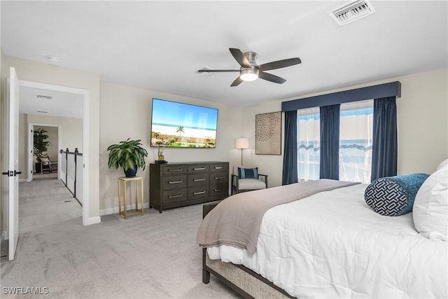 bedroom with light carpet and ceiling fan