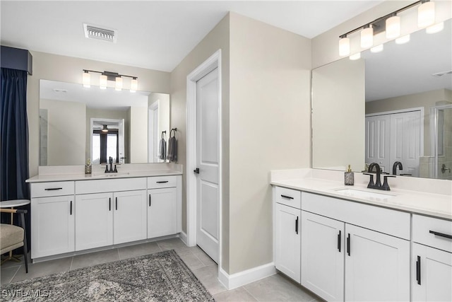 bathroom featuring tile patterned flooring and vanity