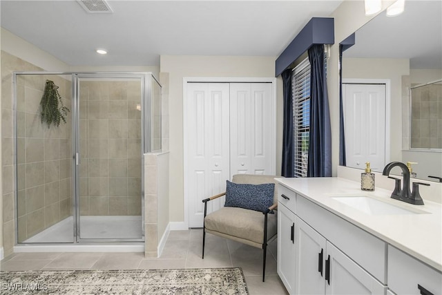 bathroom with vanity, an enclosed shower, and tile patterned floors