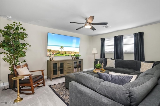 carpeted living room with ceiling fan