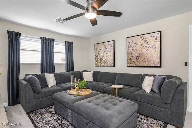 living room with ceiling fan and carpet