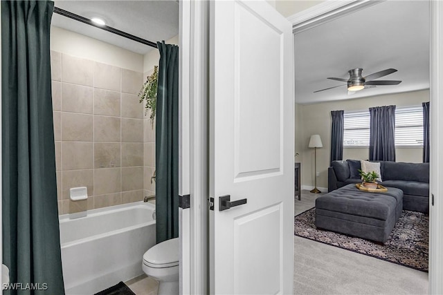 bathroom featuring ceiling fan, shower / bath combo with shower curtain, and toilet