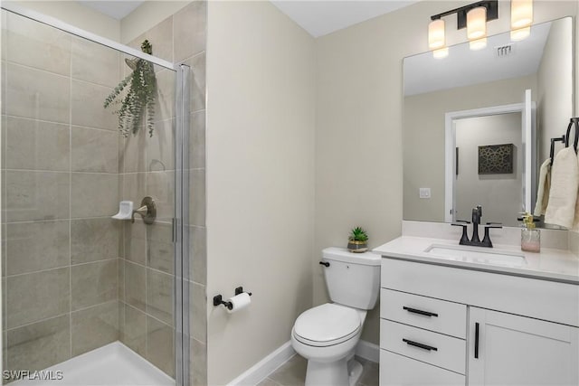 bathroom featuring toilet, a shower with door, and vanity