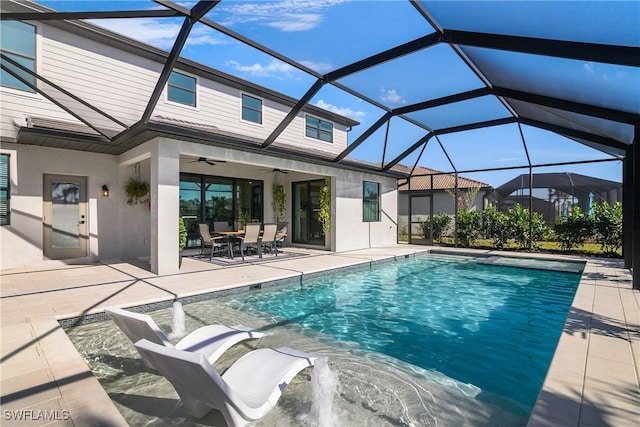 view of pool featuring a lanai, a patio, and ceiling fan