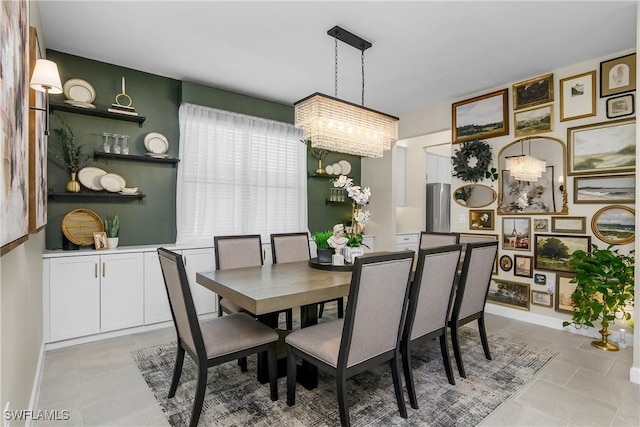 tiled dining area featuring a chandelier