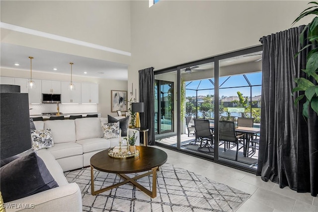 living room with a high ceiling and light tile patterned floors