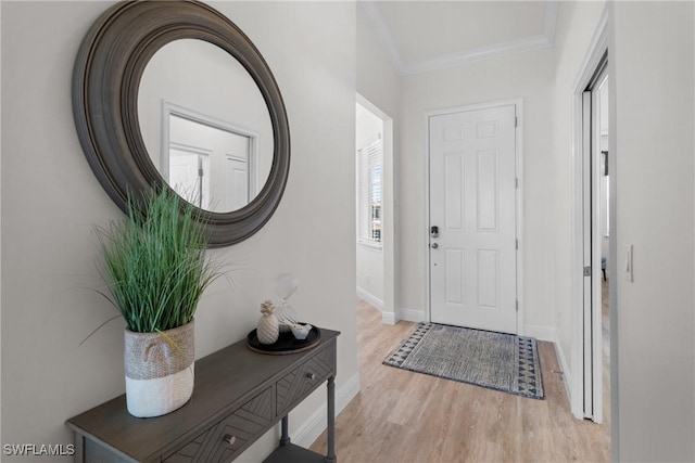 entryway featuring ornamental molding and light hardwood / wood-style flooring