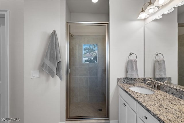 bathroom featuring vanity and a shower with door