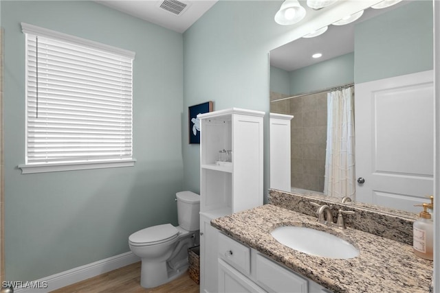 bathroom with vanity, a shower with shower curtain, wood-type flooring, and toilet