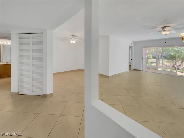 unfurnished room featuring ceiling fan and light tile patterned floors