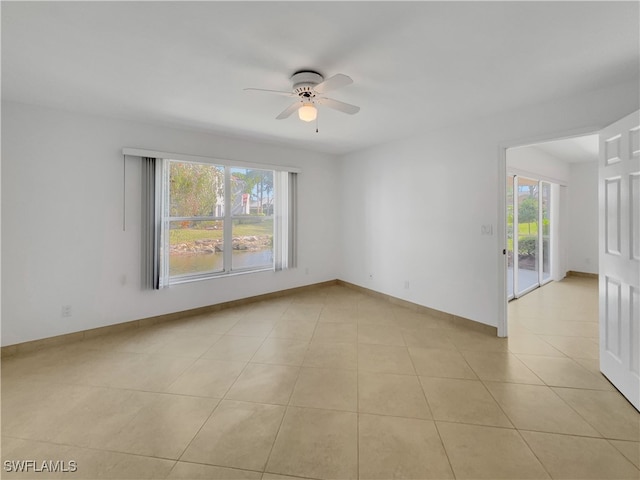 tiled empty room featuring a wealth of natural light and ceiling fan