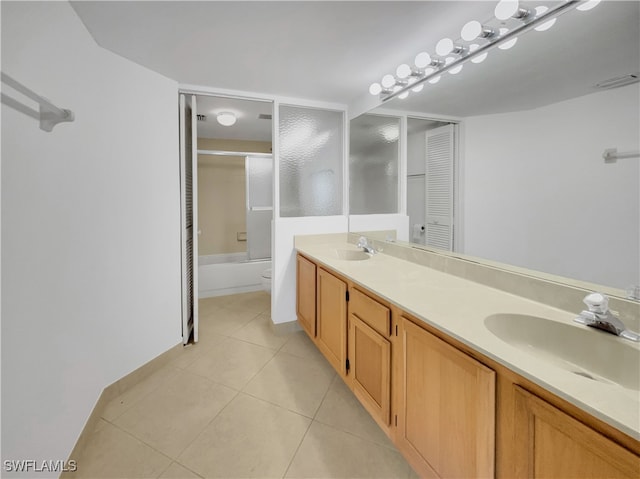 full bathroom with tile patterned flooring, vanity, toilet, and shower / bath combination with glass door