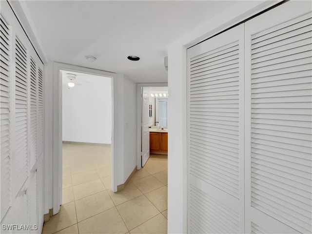 hall with light tile patterned floors