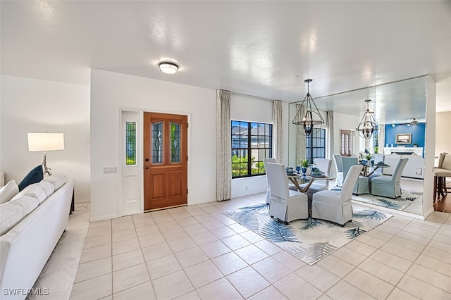 dining area featuring light tile patterned flooring and a chandelier