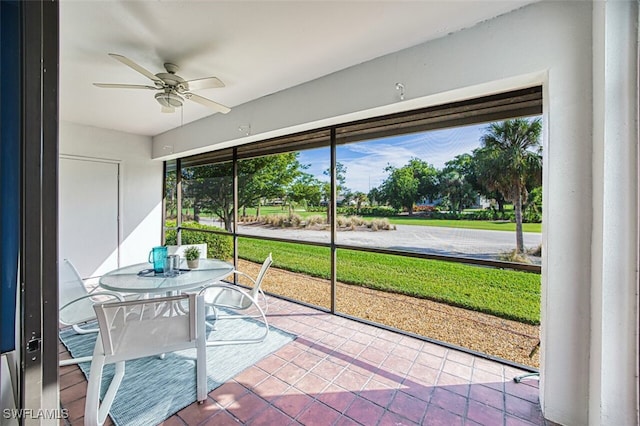 sunroom / solarium featuring ceiling fan