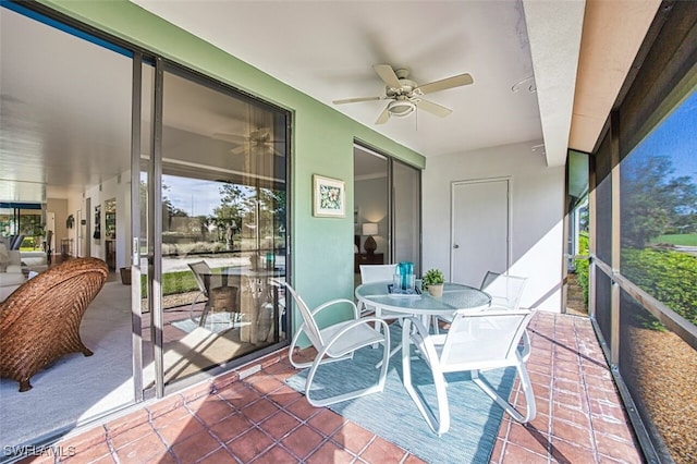 sunroom featuring ceiling fan